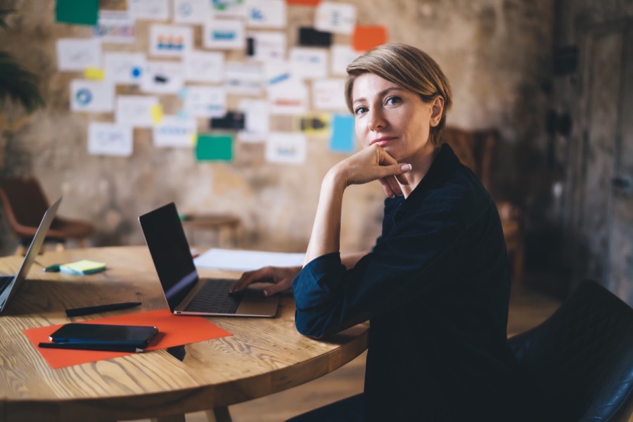 Woman entrepreneur working at a laptop in a strategy workspace